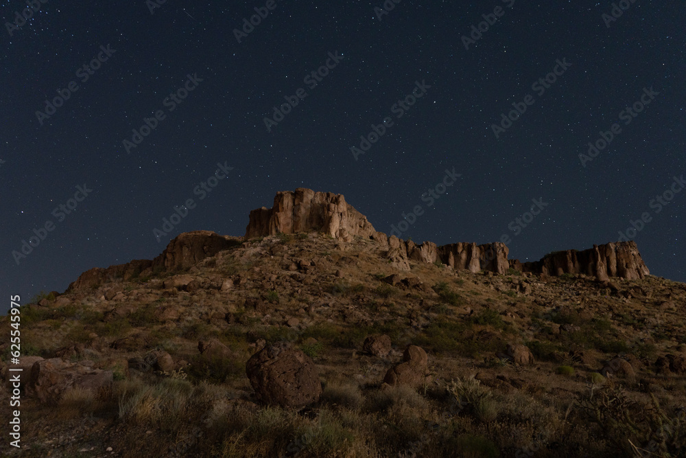 Stars above a rugged desert mountain