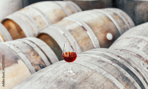 Wallpaper Mural A glass of alcoholic beverage - Portuguese sweet wine Moscatel on wooden barrels  Torontodigital.ca