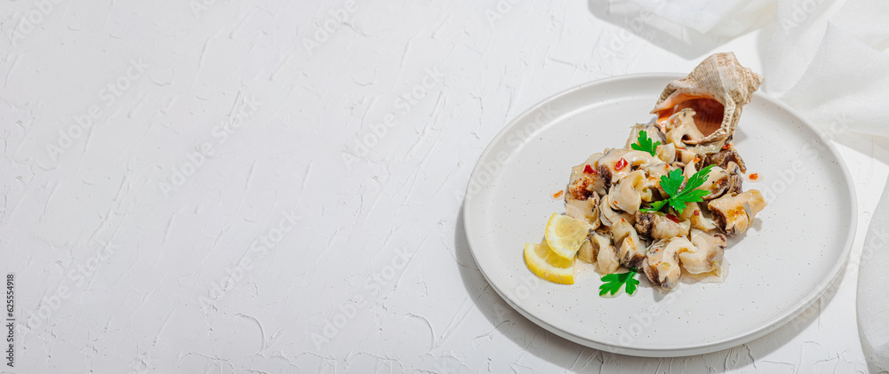 Rapana clam meat with oil, spices and greens. Healthy seafood is rich in omega. Marine decor Rapana clam meat with oil, spices and greens. Healthy seafood is rich in omega. Marine decor