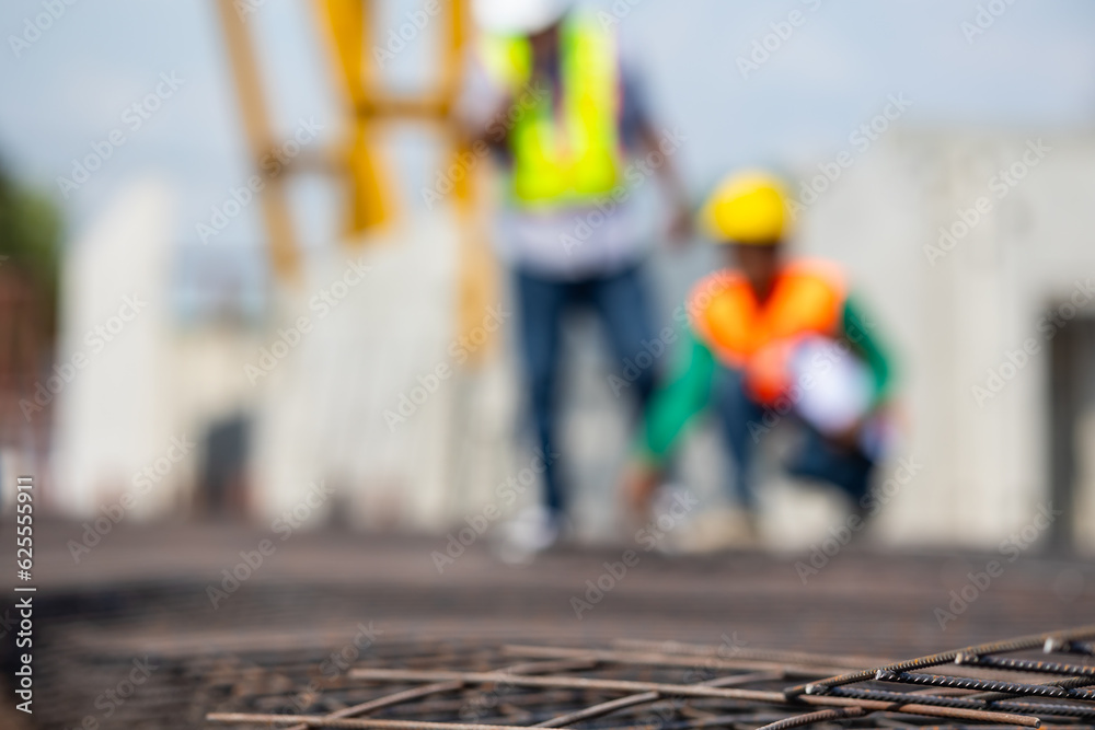 Engineer inspecting steel wire mesh for concrete slab reinforcement of construction. Professional Engineer Team working. African american holding walkie talkie with worker at Prefabricated factory Engineer inspecting steel wire mesh for concrete slab reinforcement of construction. Professional Engineer Team working. African american holding walkie talkie with worker at Prefabricated factory