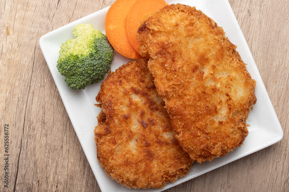 Chicken fried steak with vegetables, pancakes with garlic and herbs