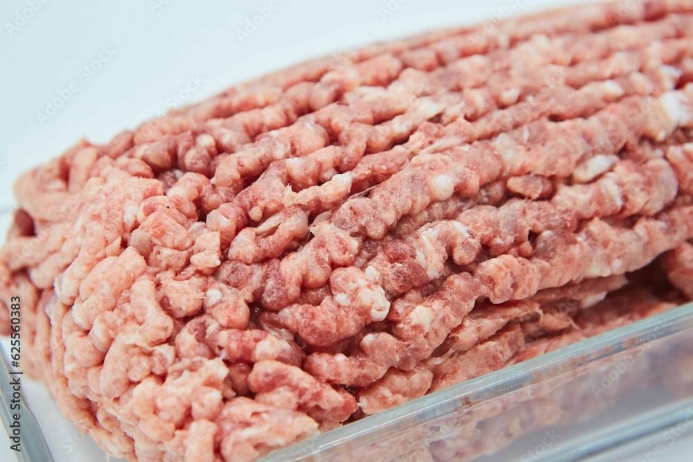 Raw meat ground into minced meat on a white background. Pork, beef or lamb. Different parts of meat products for different dishes. Raw meat ground into minced meat on a white background. Pork, beef or lamb. Different parts of meat products for different dishes.