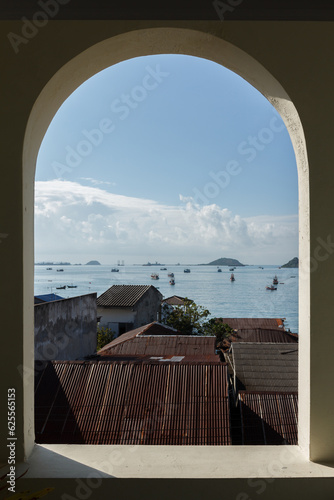Modern window with the view of the city and sea.