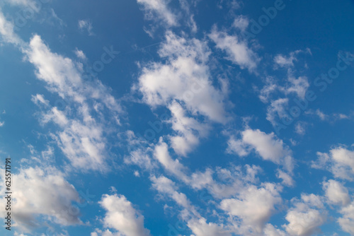 Blue sky with a few clouds background.