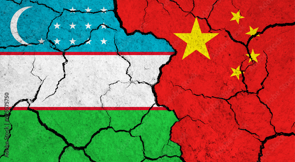 Flags of Uzbekistan and China on cracked surface - politics, relationship concept Flags of Uzbekistan and China on cracked surface - politics, relationship concept