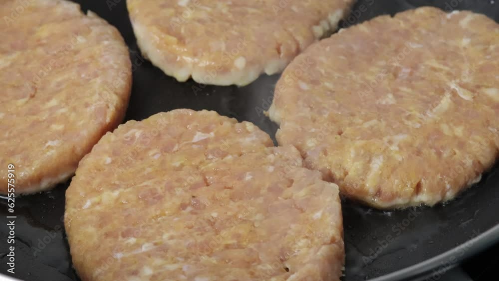 steaks hachés de poulet cuisant dans une poêle
