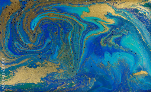 Golden Dust on Liquid Blue Ink Wave Background.
