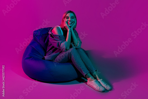 Photos Photo of positive youth lady sit beanchair dreaming isolated on ultraviolet mult