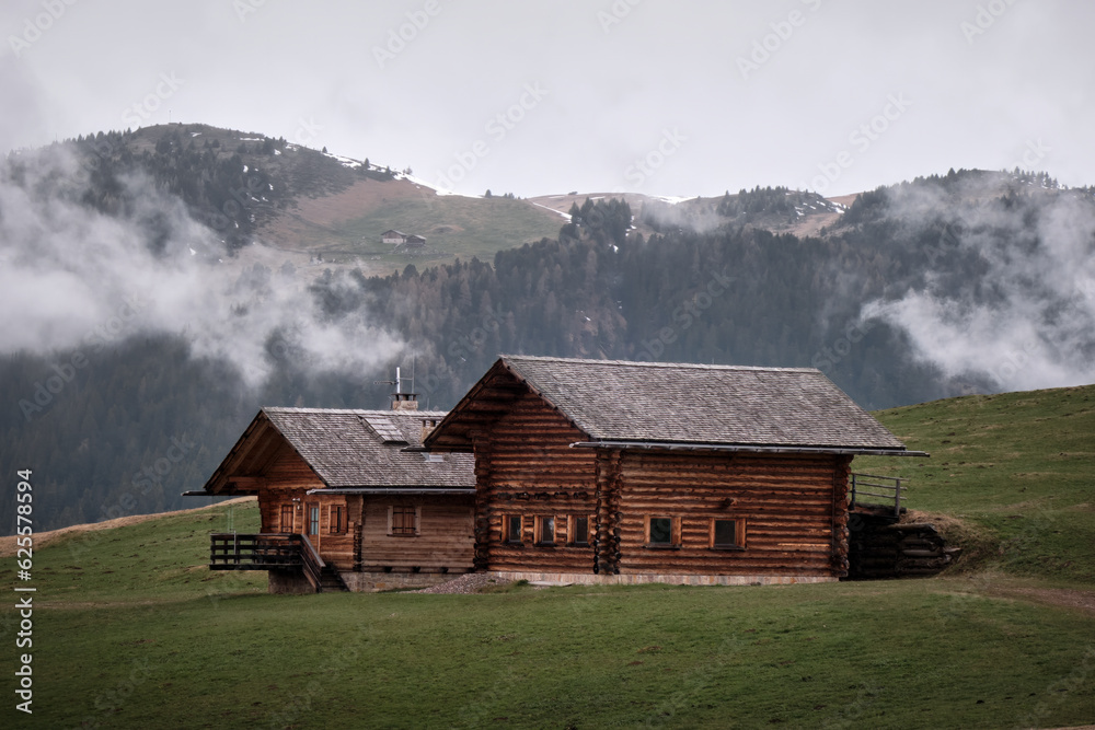  touristic houses. misty fog wooden travel cabin on the hills. Alpe di siusi, Seiser alm Italian.