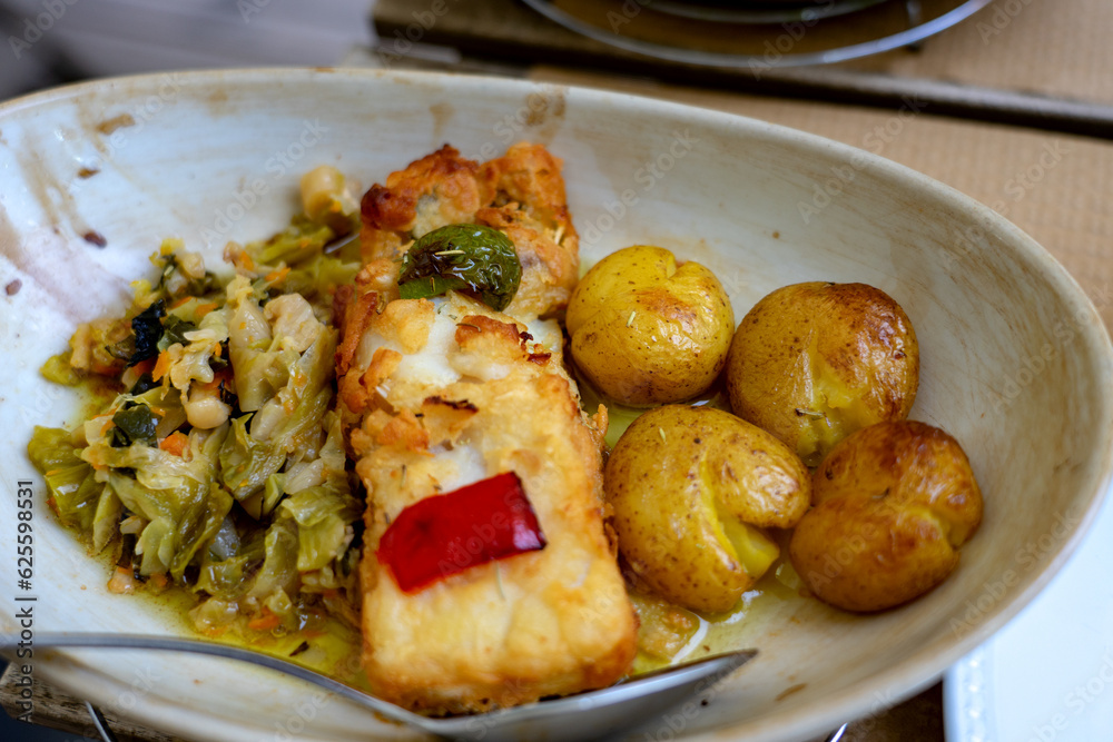 tradtional cod fish dish with potato and cabbage in Porto Portugal