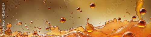 Drops of liquid on a golden amber yellow background