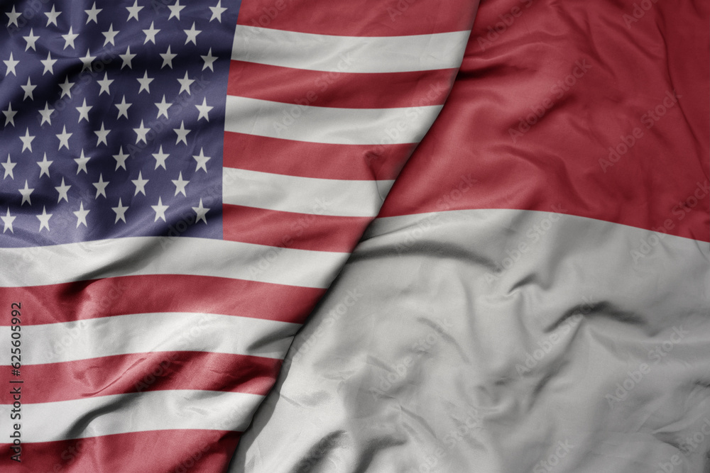 Obraz premium big waving colorful flag of united states of america and national flag of indonesia .