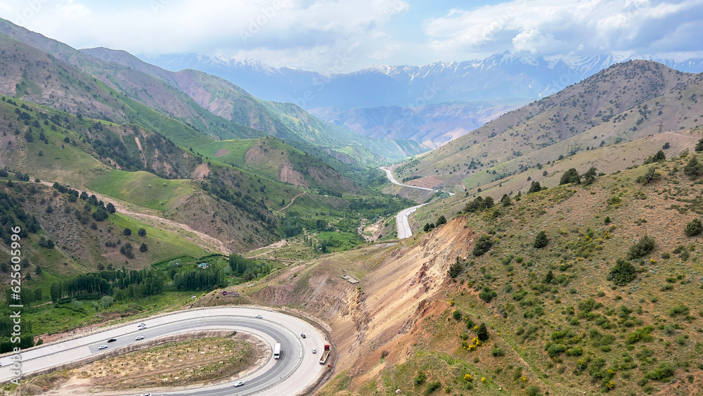 Automobile road among the picturesque mountain valley Automobile road among the picturesque mountain valley