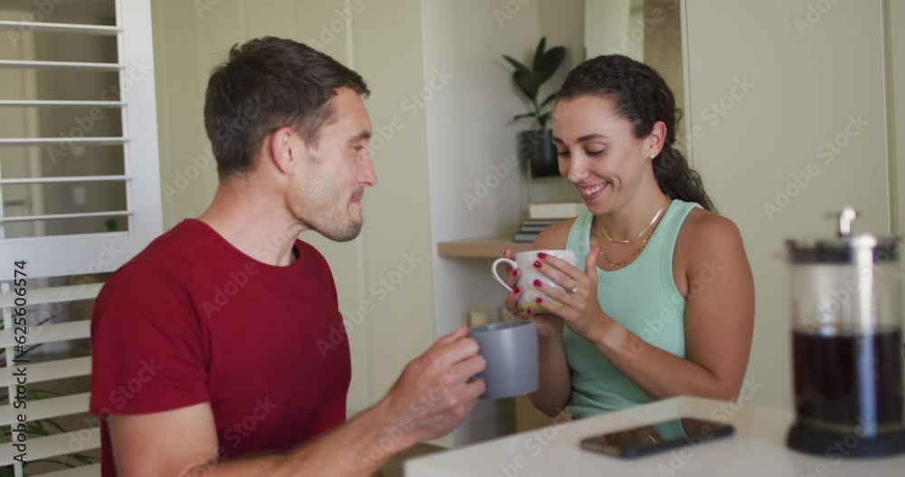 Happy caucasian couple drinking coffee and using smartphone Happy caucasian couple drinking coffee and using smartphone