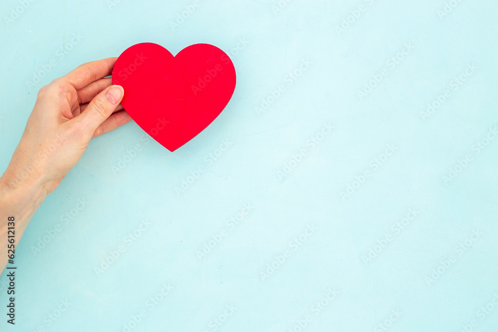 Woman holding red heart in hands. Medical insurance or health care concept