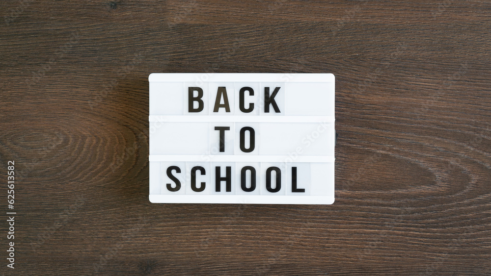 Back to school concept. School supplies on wooden background. Back to school lettering on white letter board. Copy space for text. Selective focus included Back to school concept. School supplies on wooden background. Back to school lettering on white letter board. Copy space for text. Selective focus included
