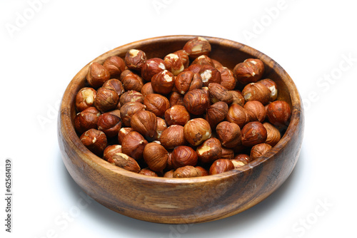 Wooden bowl full of hazelnuts on white background. Healthy eating concept. Super foods.