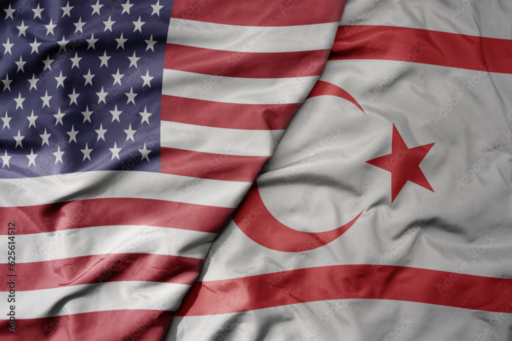 Obraz premium big waving colorful flag of united states of america and national flag of northern cyprus .