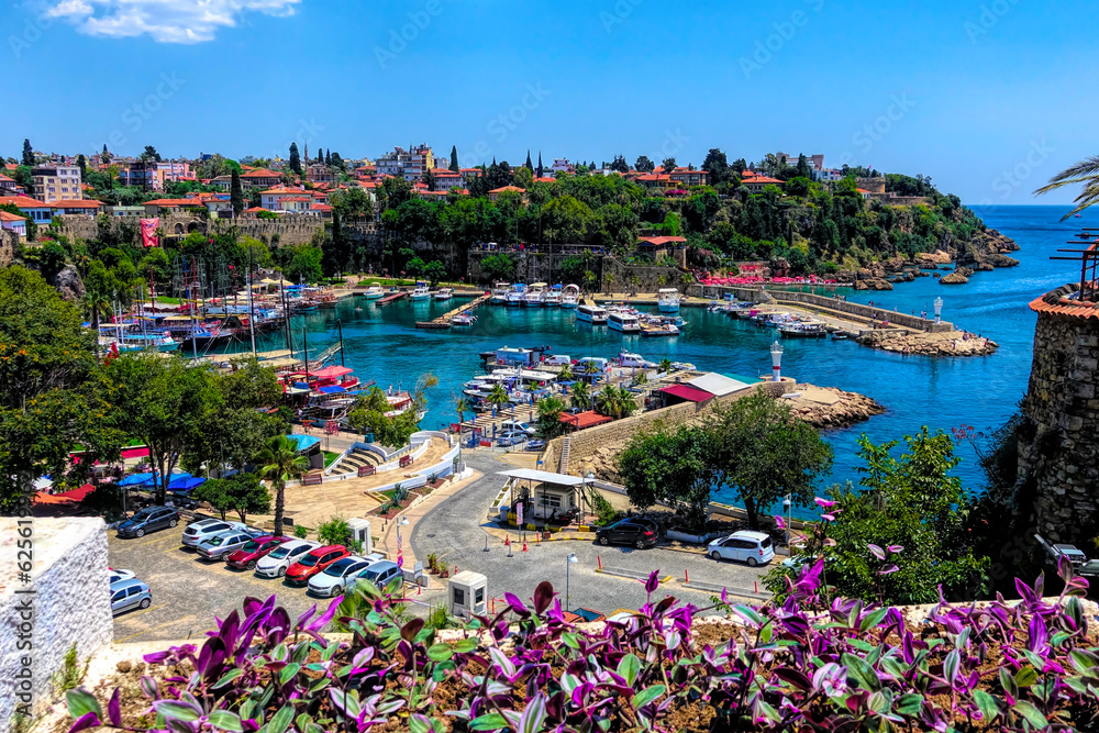 Fototapeta premium Antalya Marina Turkey with purple flowers and boats and yachts in the harbour of historic old town of Kaleici