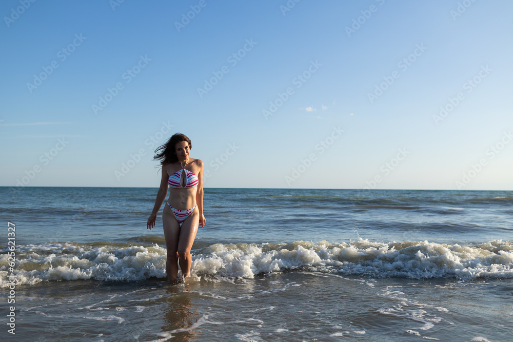 Beautiful brunette woman wearing swimsuit in sea have fun Beautiful brunette woman wearing swimsuit in sea have fun