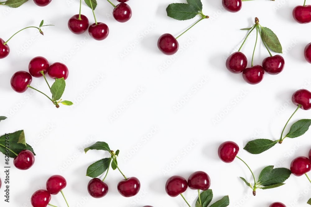 Cherry pattern. Flat lay, top view of cherries and leaves on white background.