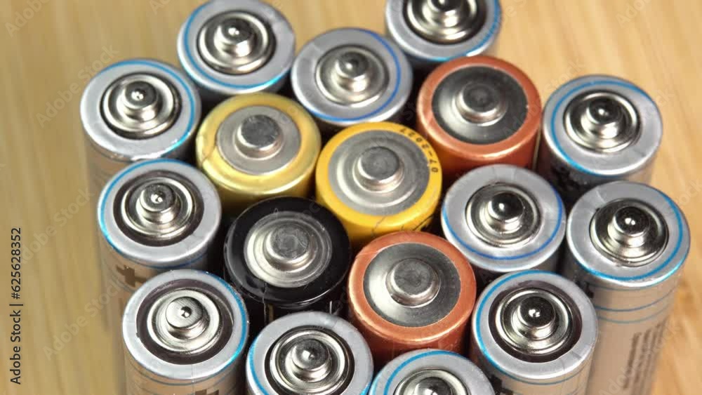 Rows of used alkaline AA batteries. Lithium ion battery pack close up. Electric power supply for electric vehicle EV. Environmental pollution, non-recyclable waste, green energy Rows of used alkaline AA batteries. Lithium ion battery pack close up. Electric power supply for electric vehicle EV. Environmental pollution, non-recyclable waste, green energy