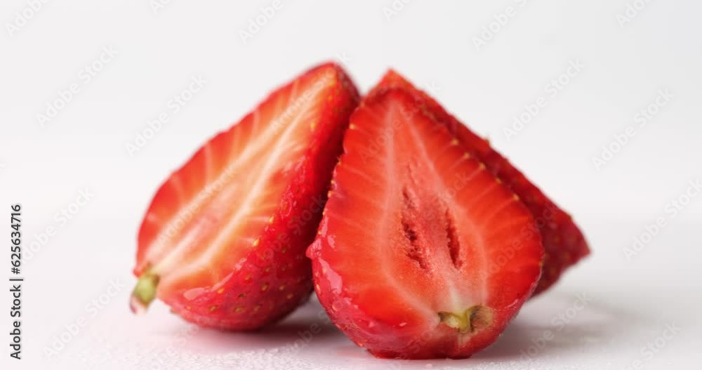 Pyramid of strawberries halves on white background. Composition of summer berries turning around. Organic vegan snack and healthy lifestyle Pyramid of strawberries halves on white background. Composition of summer berries turning around. Organic vegan snack and healthy lifestyle