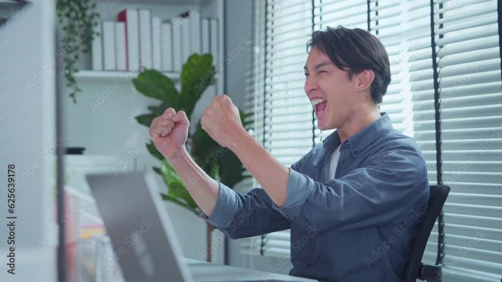 Excited Asian businessman checking email reading great news on pc computer, Professional reading good news. Happy guy enjoying victory. Business man showing yes gesture, reward bonus, celebrate