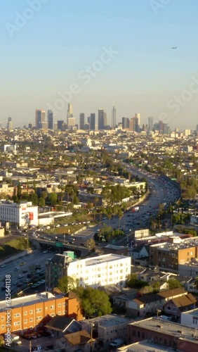 Wallpaper Mural Aerial view to the cars driving on multi-level highway in Los Angeles. Drone Point View of Overpass and City Traffic. Aerial footage of road and people traveling by cars on a highway. Vertical video Torontodigital.ca