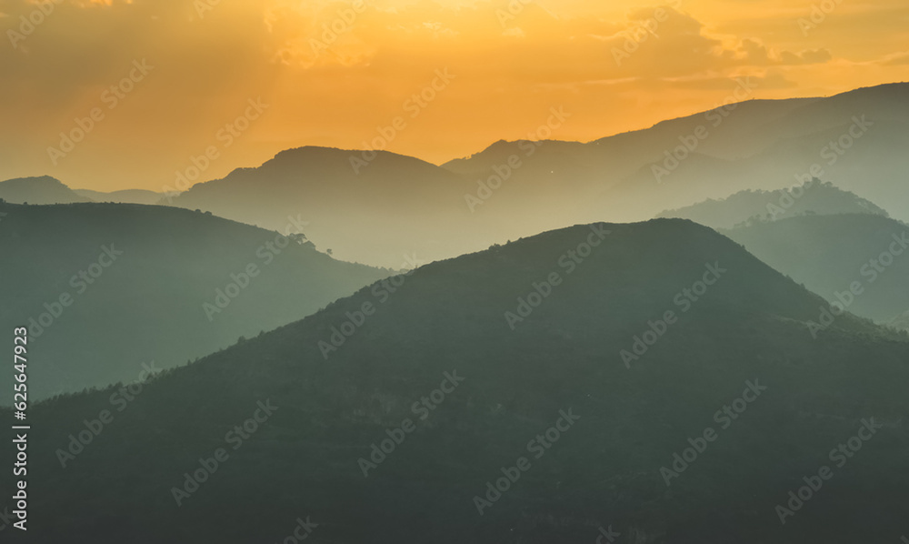 Mountains landscape on sunset. Mountain view from Mola De Segart mountain in Sierra Calderona national park in Valencia, Spain. Sunset over mountains. Landscape of a mountain valley. Hill on sunrise.