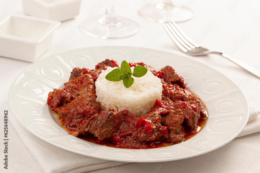 A delicious beef stew with rice and paprika sauce A delicious beef stew with rice and paprika sauce