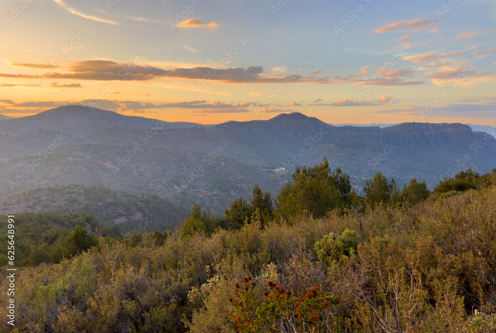 Mountains landscape on sunset. Mountain view from Mola De Segart mountain in Sierra Calderona national park in Valencia, Spain. Sunset over mountains. Landscape of a mountain valley. Hill on sunrise.