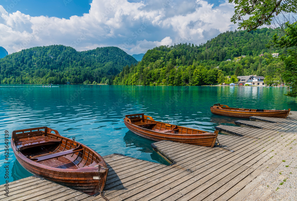 A view past boats along the shore of Lake Bled in Bled, Slovenia in summertime