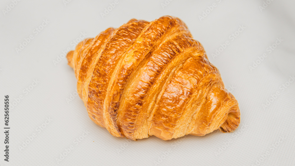Golden Perfection Artisan Croissant in Natural Morning Light. Golden Perfection Artisan Croissant in Natural Morning Light.