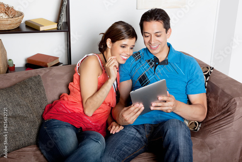 Couple using a tablet computer/e-reader photo