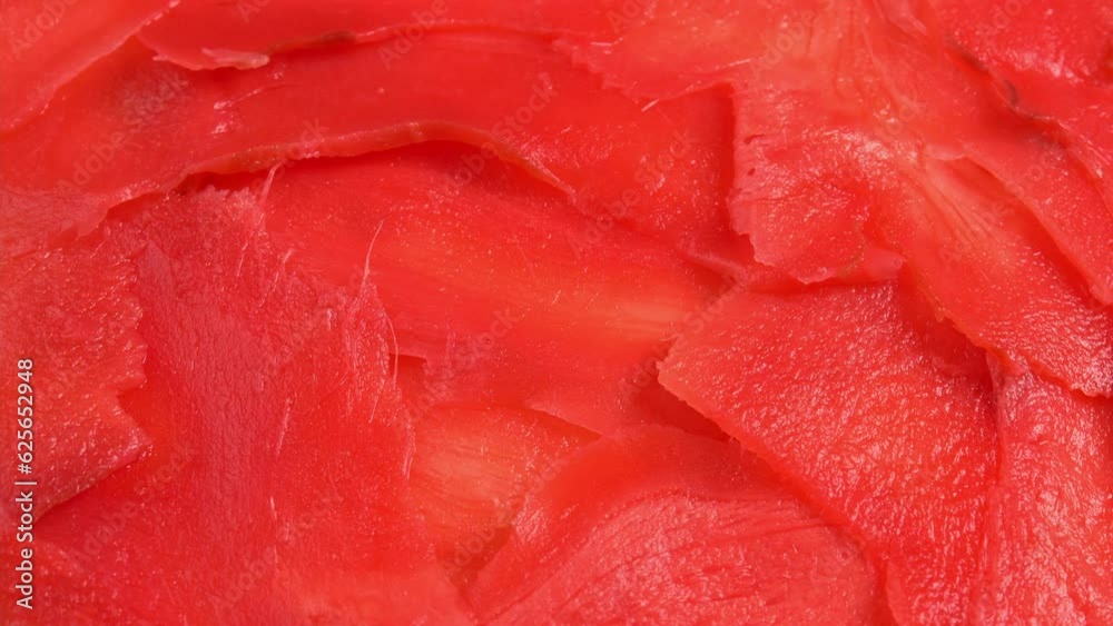 Red pickled ginger for sushi rolls rotates like background for restaurant, bars, public catering, screens. Colored Pickled Ginger for Japanese Cuisine Red pickled ginger for sushi rolls rotates like background for restaurant, bars, public catering, screens. Colored Pickled Ginger for Japanese Cuisine
