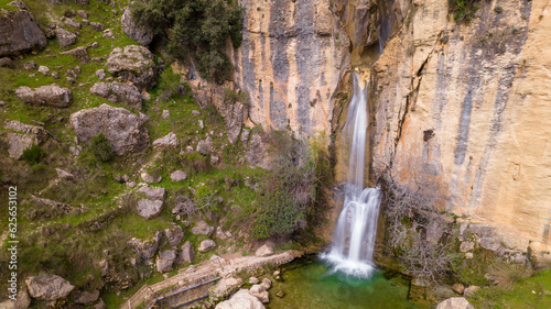 Long exposure photography of a waterfall in a famous canyoning area in the Castril Natural Park. Silky water effect with relaxing and lonely atmosphere. Granada. Andalusia. Spain. photo