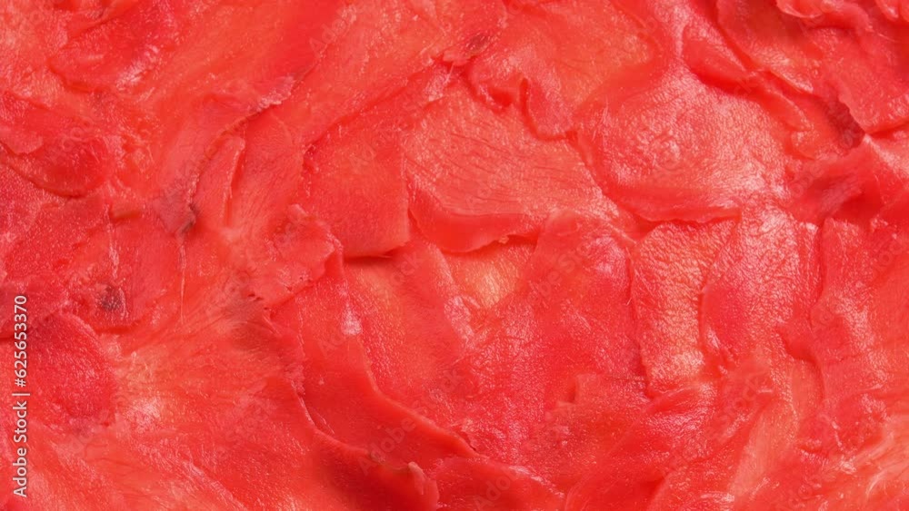 Red pickled ginger for sushi rolls rotates like background for restaurant, bars, public catering, screens. Colored Pickled Ginger for Japanese Cuisine Red pickled ginger for sushi rolls rotates like background for restaurant, bars, public catering, screens. Colored Pickled Ginger for Japanese Cuisine