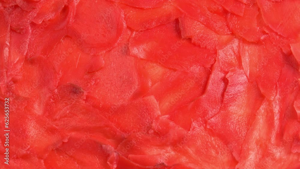 Red pickled ginger for sushi rolls rotates like background for restaurant, bars, public catering, screens. Colored Pickled Ginger for Japanese Cuisine Red pickled ginger for sushi rolls rotates like background for restaurant, bars, public catering, screens. Colored Pickled Ginger for Japanese Cuisine