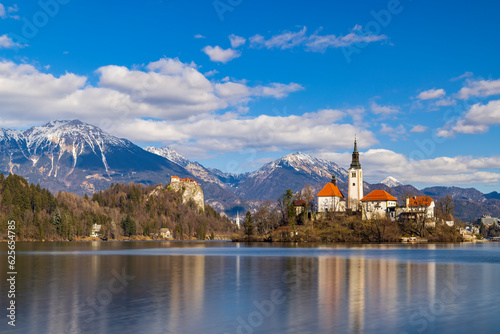 Bled lake with Bled catle, church and winter Julian Alps at background