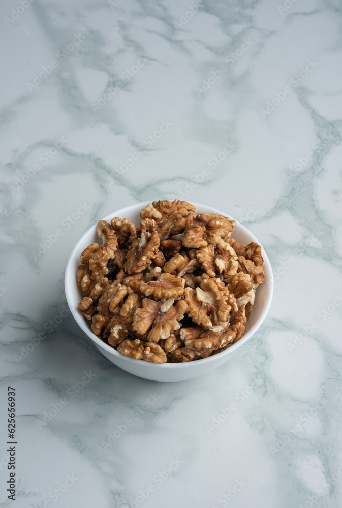 Walnut in a bowl on marble table Walnut in a bowl on marble table