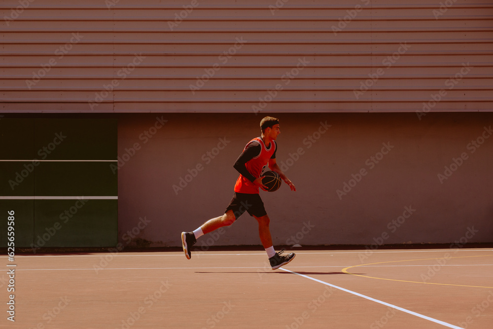 A basketball player plays streetball on a hot day.