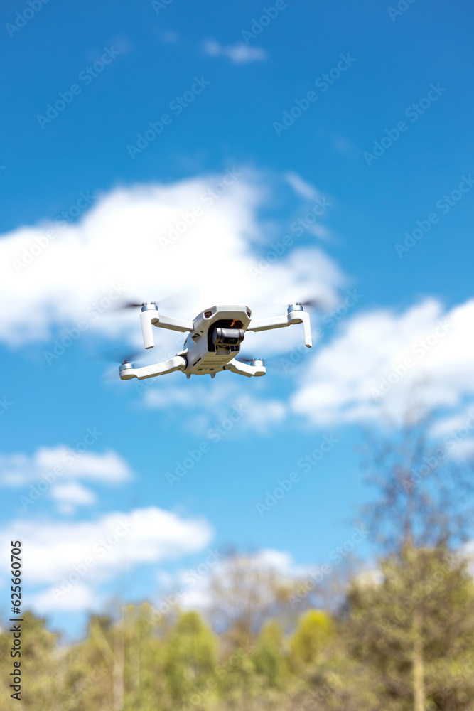 drone flying in silhouette against the blue sky, copter on a blurred background in the sunlight, slow motion drone flying in silhouette against the blue sky, copter on a blurred background in the sunlight, slow motion