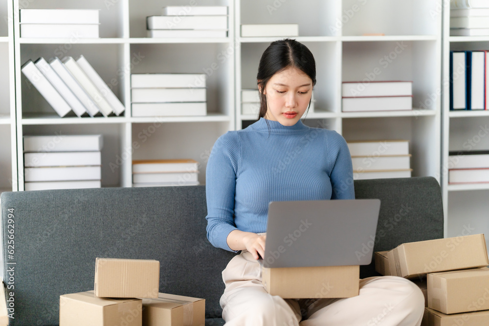 Young business owner woman prepare parcel box and standing check online orders for deliver to customer on tablet, laptop Shopping Online concept. Young business owner woman prepare parcel box and standing check online orders for deliver to customer on tablet, laptop Shopping Online concept.