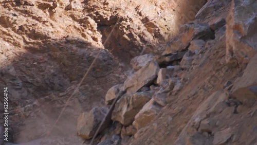 Slow motion shot of Rocks falling from mountain due to landslide in Manali, Himachal Pradesh, India. Natural disaster in mountains during monsoon. Calamity in the Himalayas.