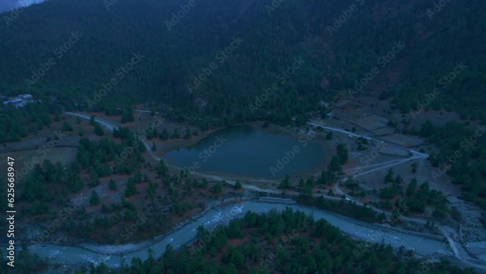 Aerial panoramic view green Pisang lake surrounded by forests in Gandaki, Nepal. Lower Pisang panorama. Annapurna circuit trekking. Gandaki. Aerial panoramic view green Pisang lake surrounded by forests in Gandaki, Nepal. Lower Pisang panorama. Annapurna circuit trekking. Gandaki.