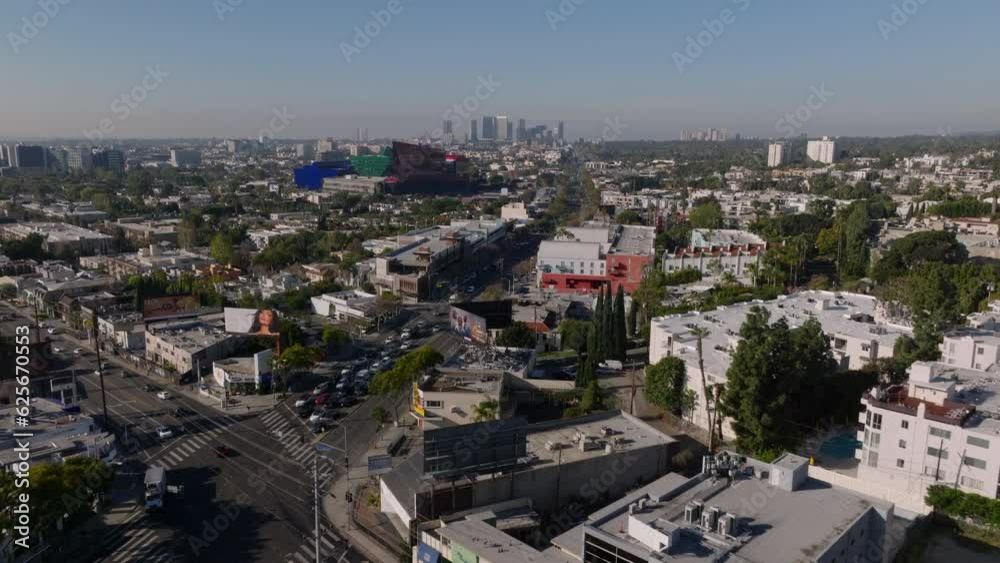 Aerial panoramic view of metropolis, traffic in streets around Pacific Design Center. High rise office buildings in distance. Los Angeles, California, USA Aerial panoramic view of metropolis, traffic in streets around Pacific Design Center. High rise office buildings in distance. Los Angeles, California, USA