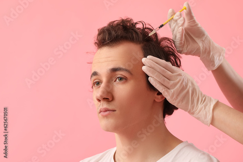Young man receiving injecti...