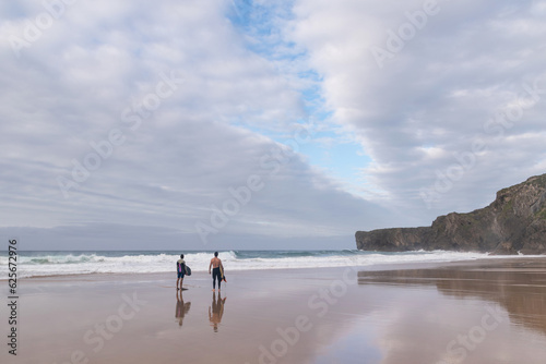 Bodyboarders watching the waves from the beach. Asturias photo