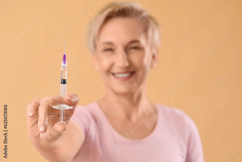 Mature woman with filler injection on beige background, closeup Mature woman with filler injection on beige background, closeup